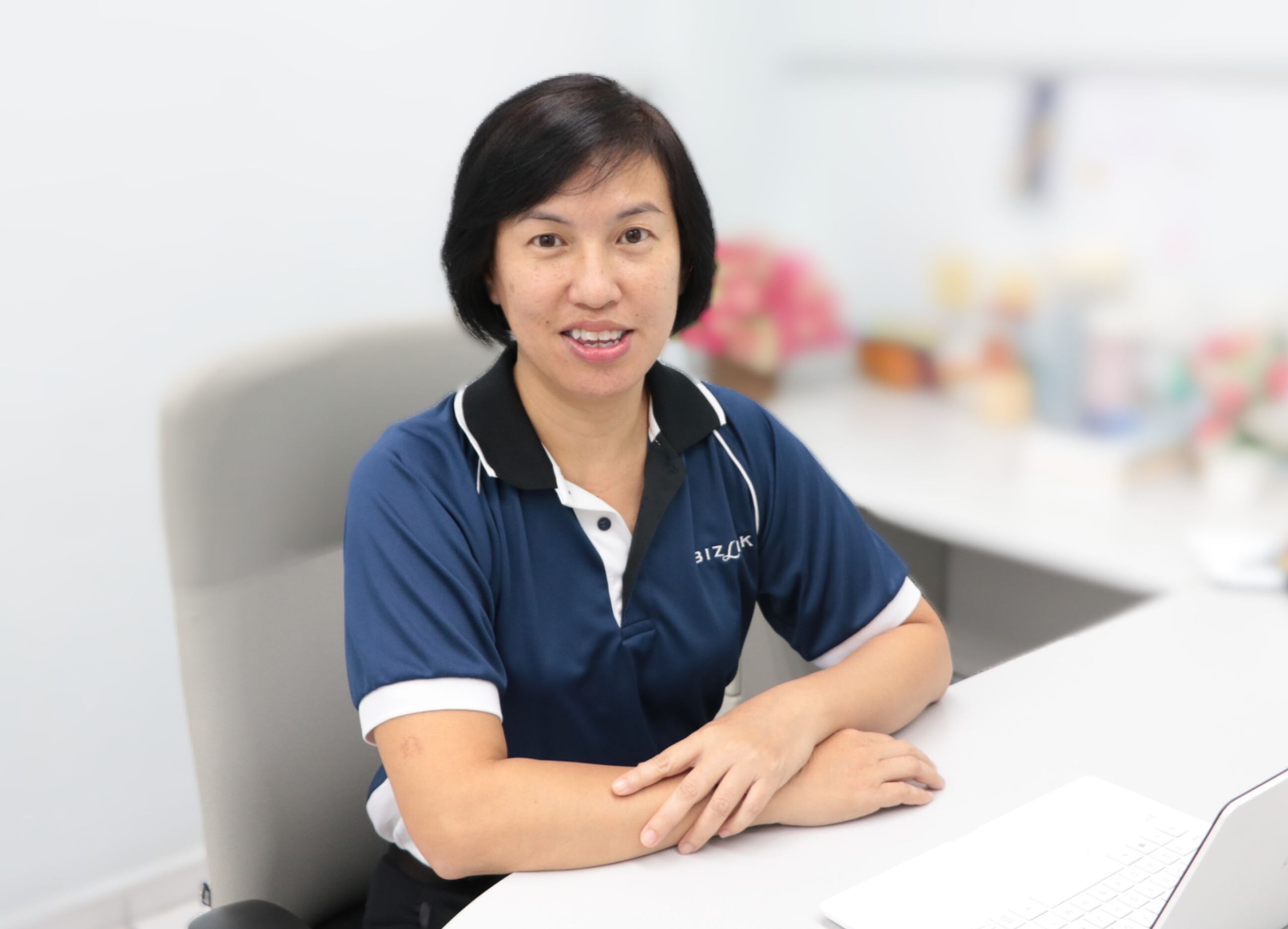 Image of CEO Li May with her hands on her desk